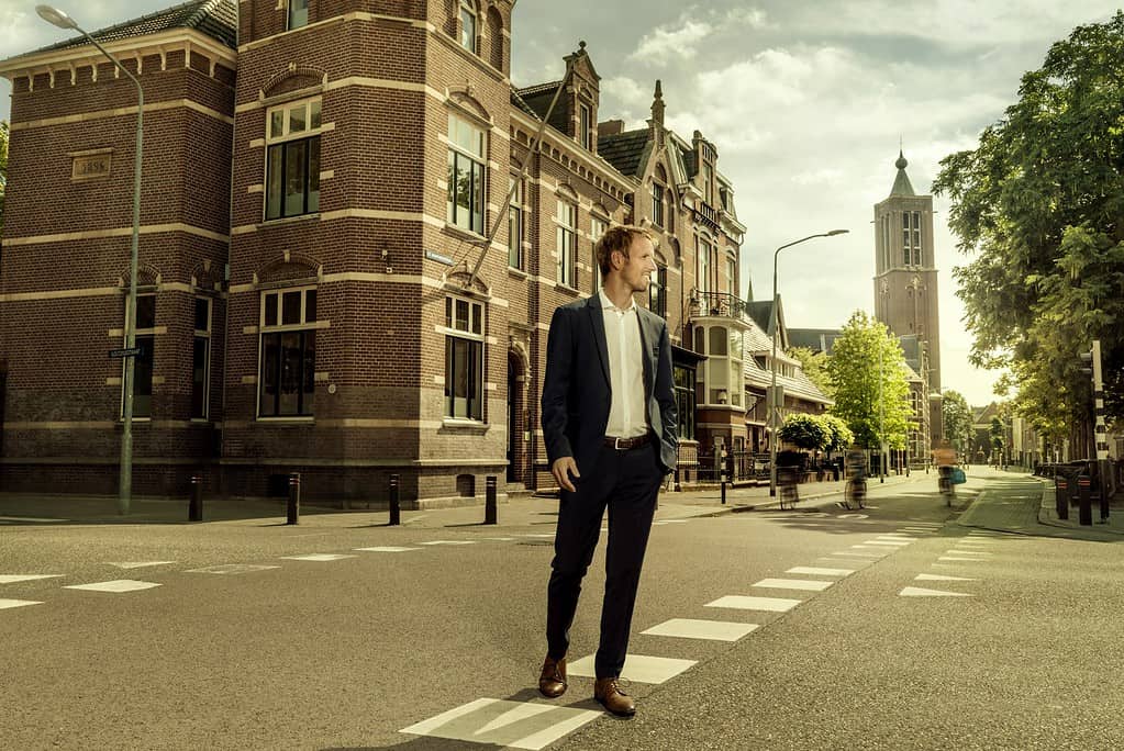 Netherlands, Venlo, businessman walking on a street