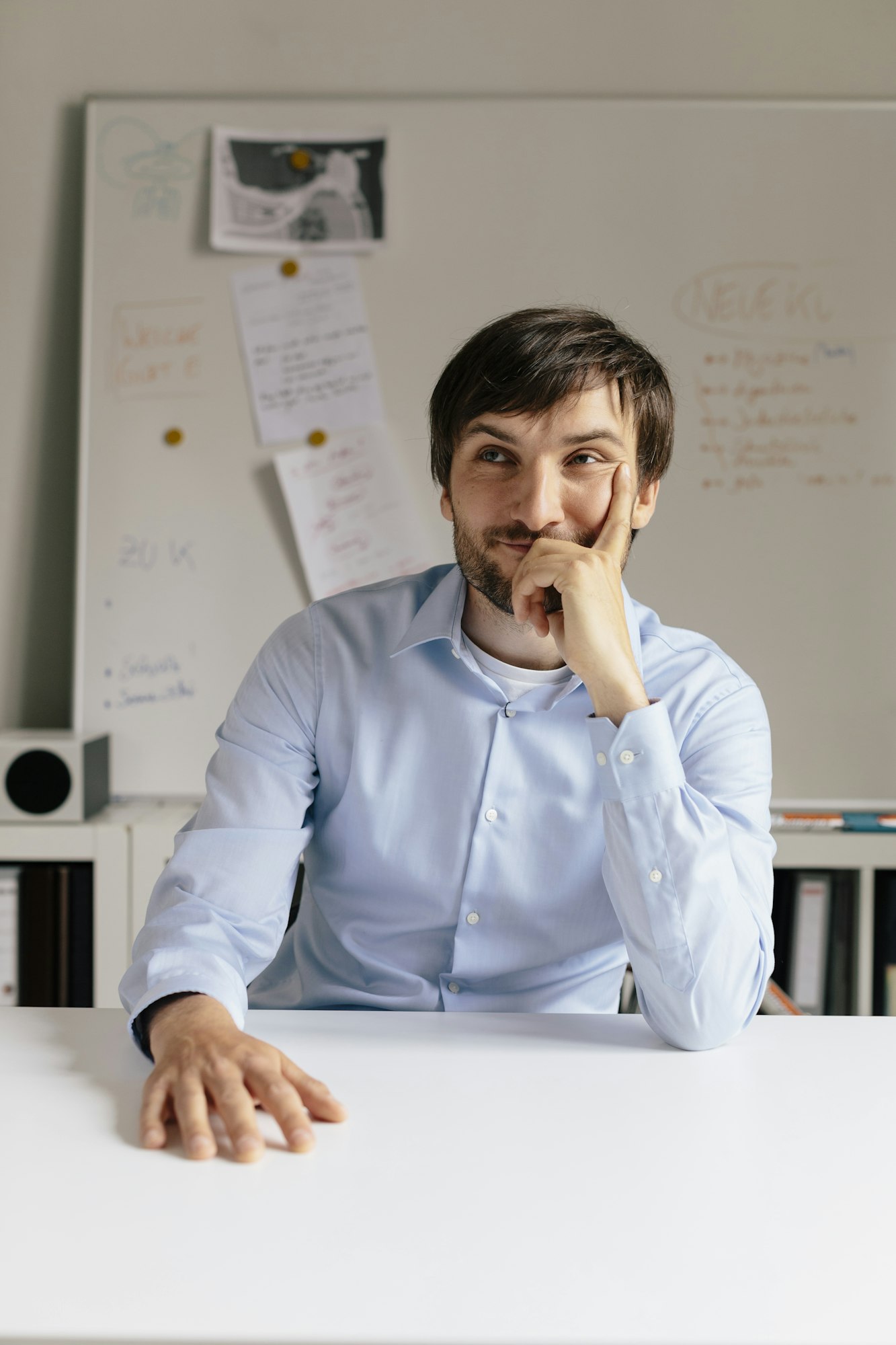 Portrait of smiling businessman at desk in office